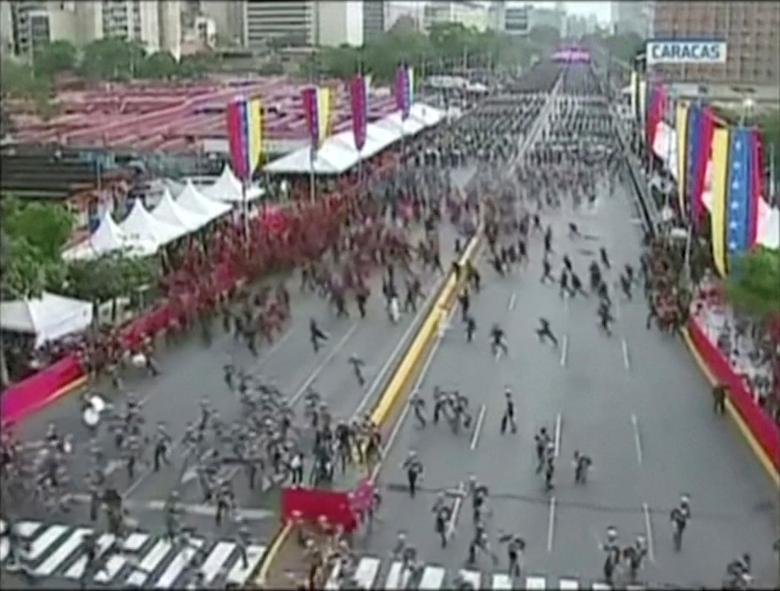 Venezuelan National Guard soldiers run during an event which was interrupted, August 4, 2018. The government said suspects launched two DJI M600 drones laden with C4 explosives over an outdoor rally on Saturday afternoon, which had been held to commemora