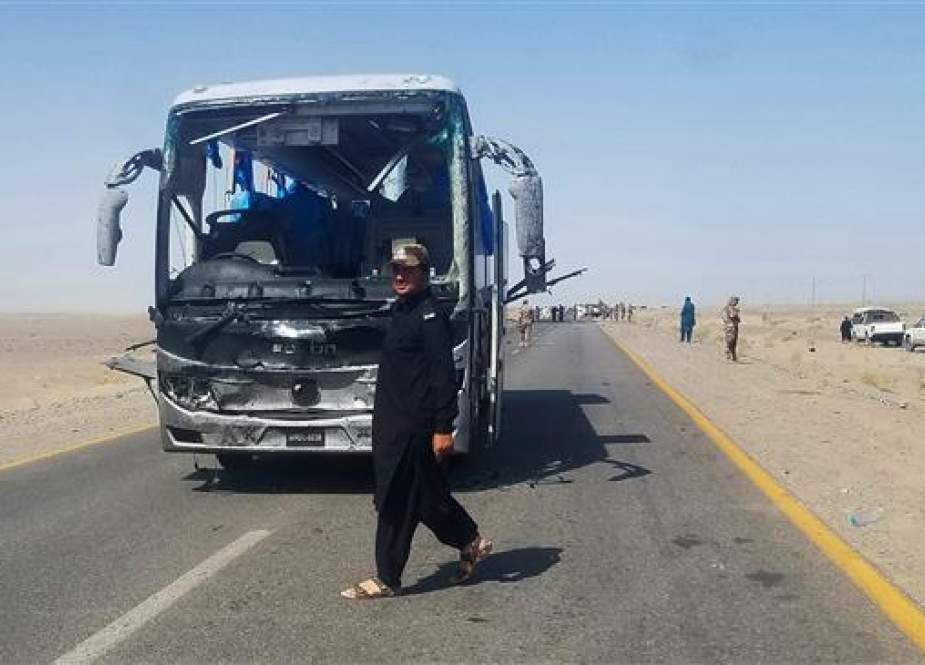 A Pakistani security personnel walks next to a damaged bus, which carried Chinese engineers from a mine in Dalbandin region, around 340 kilometers from Quetta, the capital of southwestern Balochistan Province, on August 11, 2018. (Photo by AFP)