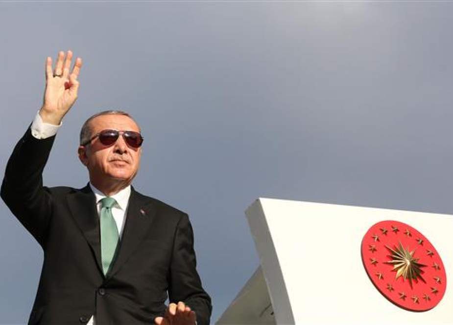 This handout picture, taken and released on August 12, 2018 by the Turkish Presidential Press Office, shows Turkish President Recep Tayyip Erdogan greeting his supporters in the Black Sea city of Trabzon. (Via AFP)