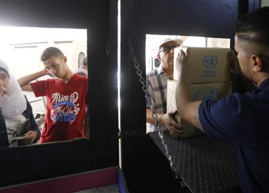 UN agency for Palestinian refugees (UNRWA) aid center at the Jaramana Palestinian refugee camp in the Syrian.jpg