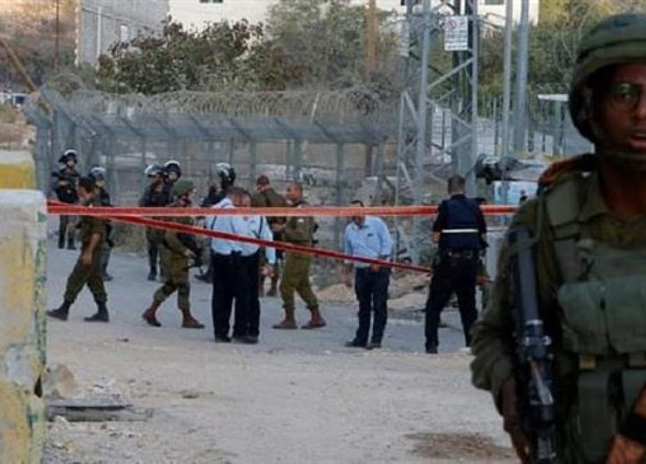 Israeli soldiers man a checkpoint outside the settlement of Kiryat Arba