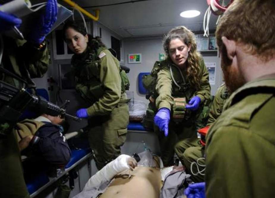 Israeli soldiers give initial medical treatment to wounded militants in the Israeli-occupied Golan Heights.jpg
