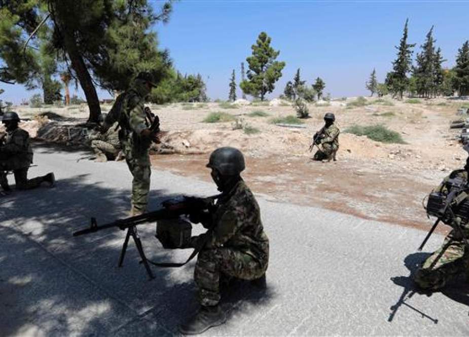 Foreign-backed militants are seen in the countryside of Syria
