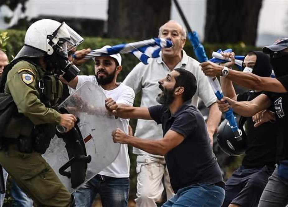 Protesters clash with police during a demonstration against the agreement reached by Greece and Macedonia to resolve a dispute over the former Yugoslav republic