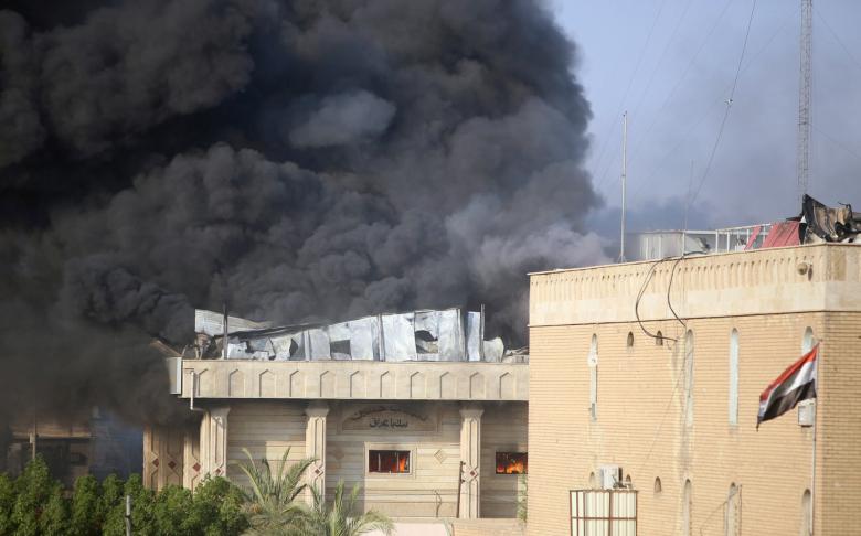 Smoke rises from the governorate and municipalities buildings of Basra, September 6, 2018.