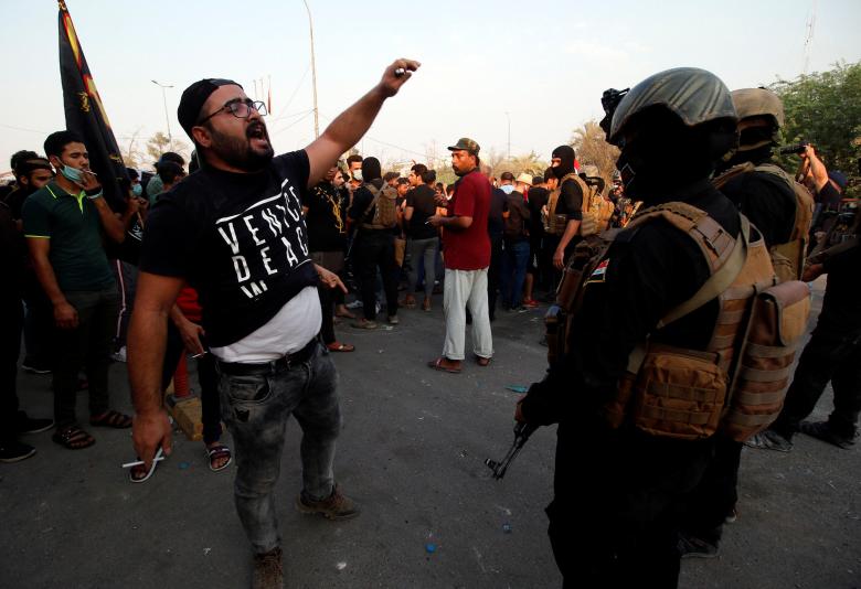 Protesters stand in front of Iraqi security forces during a protest in Basra, September 5, 2018.