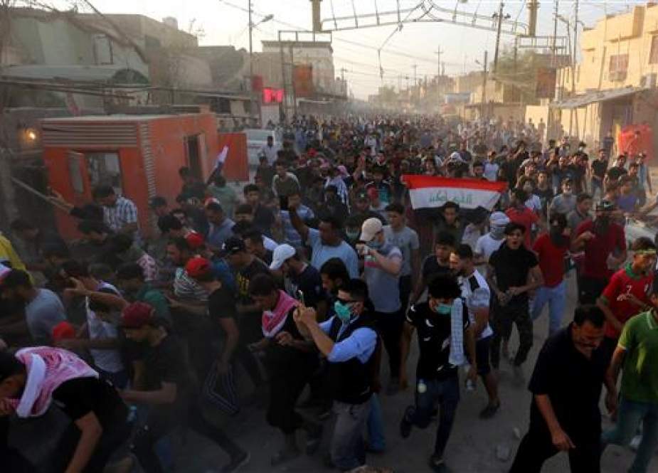 Iraqi protesters gather near the building of the government office in the city of Basra