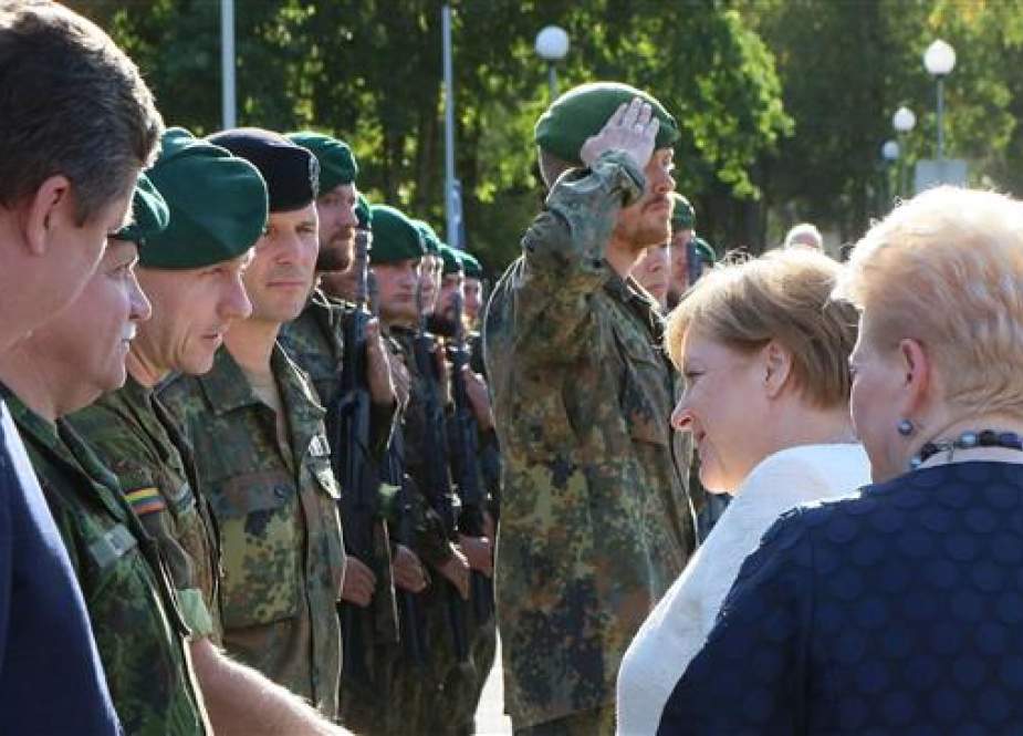 German Chancellor Angela Merkel addresses German soldiers as she pays a visit to Lithuania on September 14, 2018. (Photo by AFP)