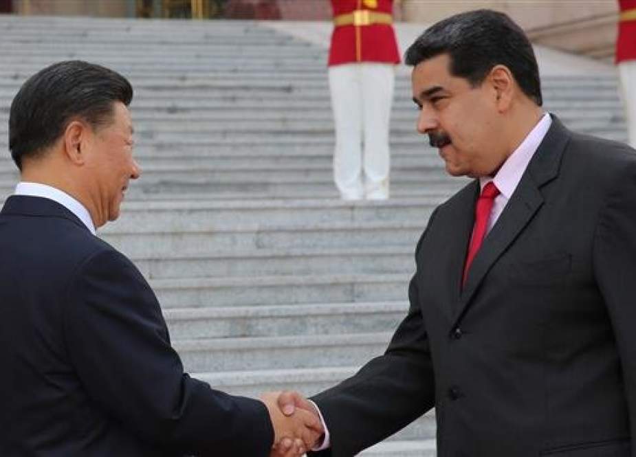 A handout picture taken and released by the Venezuelan presidency on September 14, 2018 shows Venezuelan President Nicolas Maduro (R) shaking hands with his Chinese counterpart, Xi Jinping, during a welcoming ceremony in Beijing, China. (Via AFP)