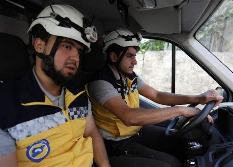 White Helmets sitting in an ambulance in the militant-held Syrian city of Idlib.jpg