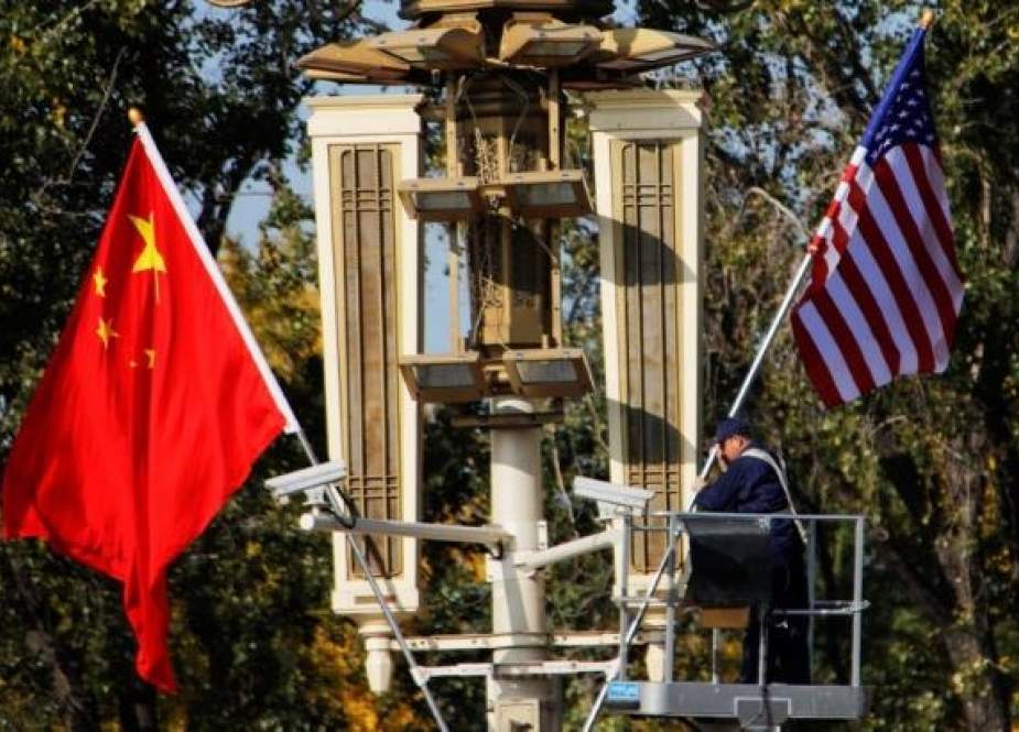 A worker places US and China flags near the Forbidden City ahead of a visit by US President Donald Trump to Beijing, in Beijing, China, on November 8, 2017. (Photo by Reuters)