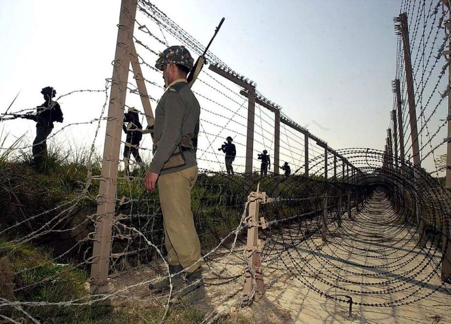 The file photo shows Indian soldiers as they patrol along a barbed-wire fence on the Line of Control (LoC) between Pakistan and India. (By AFP)