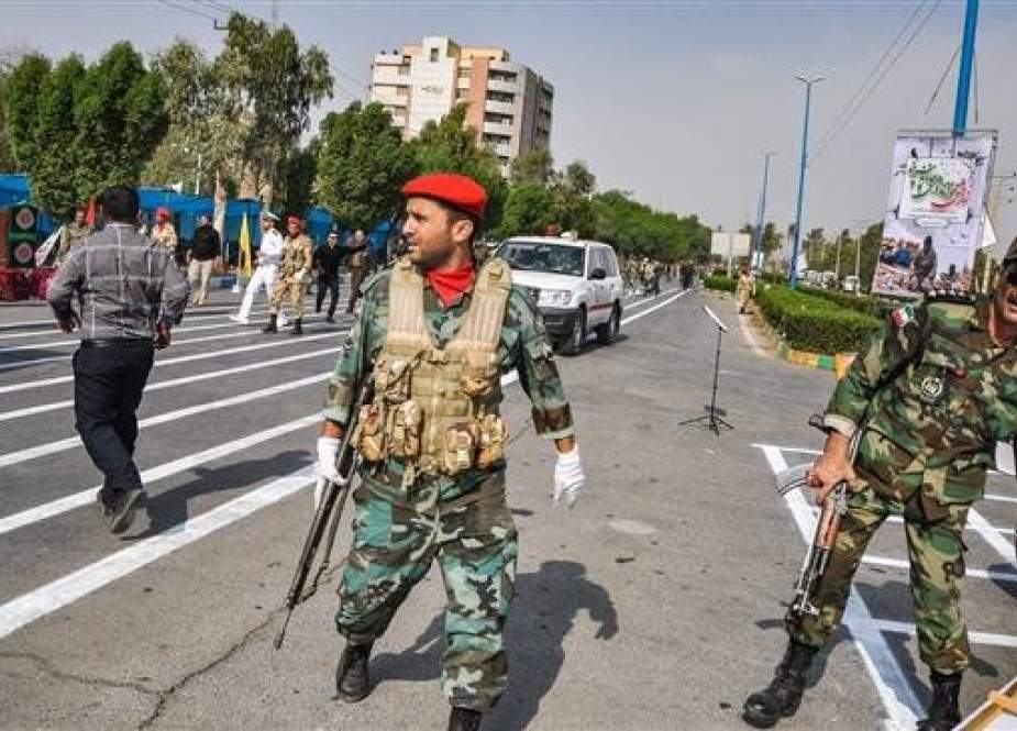 In the southwestern Iranian city of Ahvaz, soldiers are seen at the scene of an attack on a military parade. (Photo by ISNA)