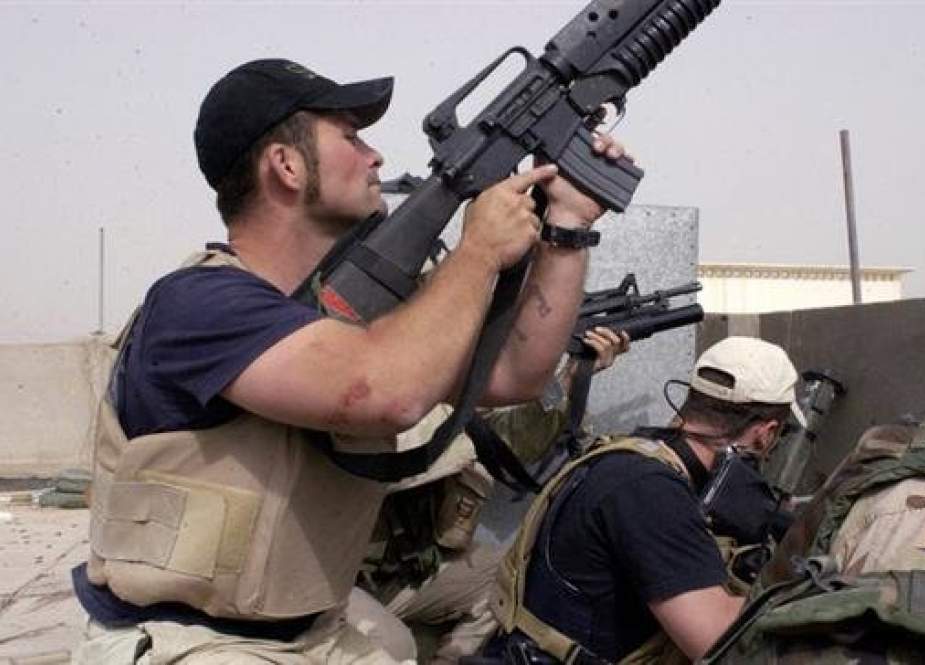 Plainclothes contractors working for Blackwater USA take part in a firefight.jpg