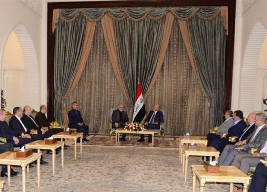 An image provided by the Islamic Republic News Agency (IRNA) shows Iraqi President Barham Saleh (background-R) meeting with Iran