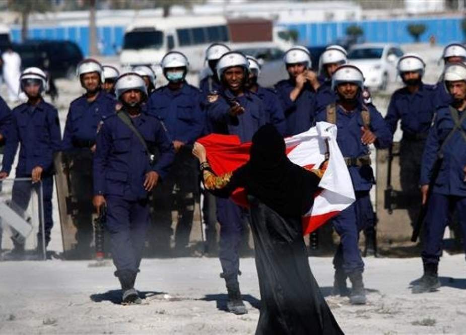 In this file picture, an anti-regime protester gestures in front of police as demonstrators re-occupy Pearl roundabout in Manama, Bahrain. (Photo by Getty Images)