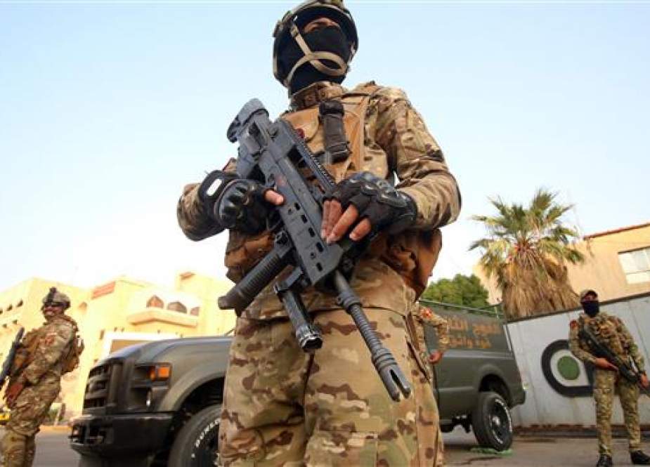 Iraqi special forces patrol in a street in Basra