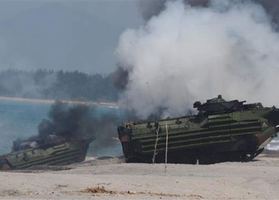 Amphibious Assault Vehicles (AAV) of the US marines emit white smoke during an amphibious landing exercise at the beach of the Philippine navy training center facing the South China sea in San Antonio town, Zambales province, north of Manila on October 6, 2018. (Photo by AFP)