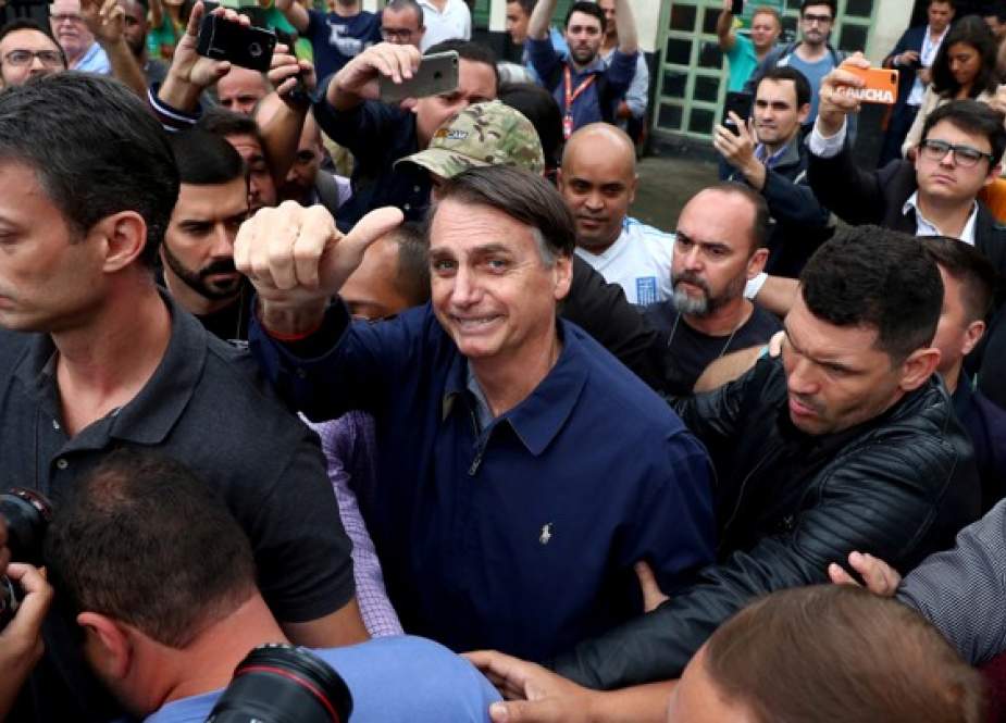 Jair Bolsonaro, far-right lawmaker and presidential candidate of the Social Liberal Party (PSL), gestures after casting his vote, in Rio de Janeiro, Brazil.