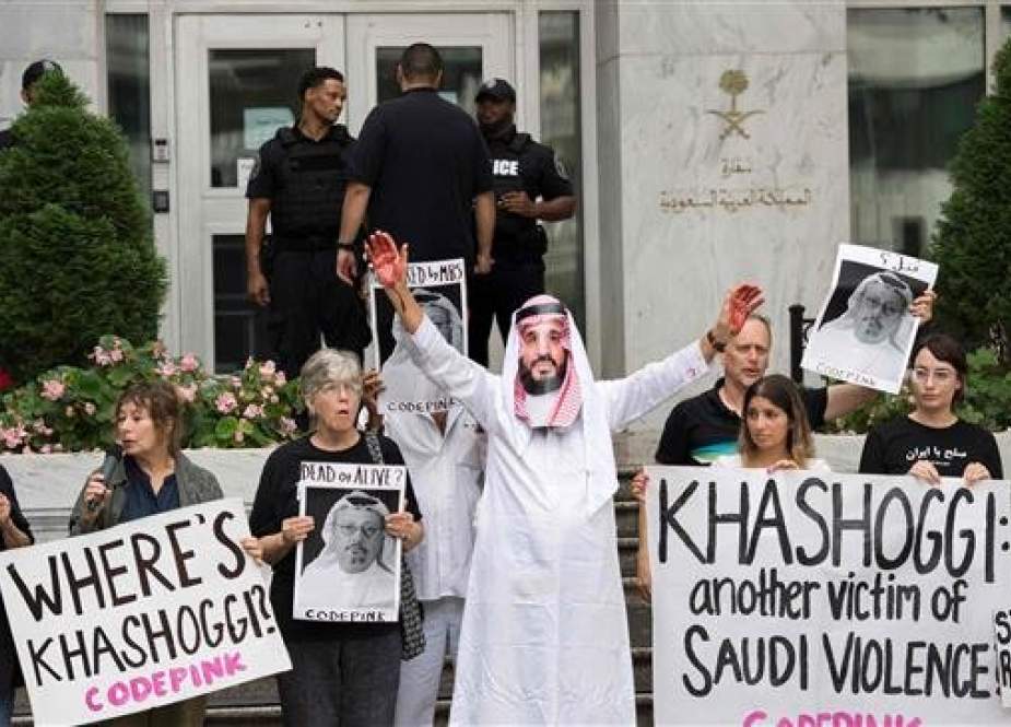 A demonstrator dressed as Saudi Crown Prince Mohammed bin Salman (C) with blood on his hands protests outside the Saudi embassy in Washington on October 8, 2018, demanding justice for missing Saudi journalist Jamal Khashoggi. (Photo by AFP)