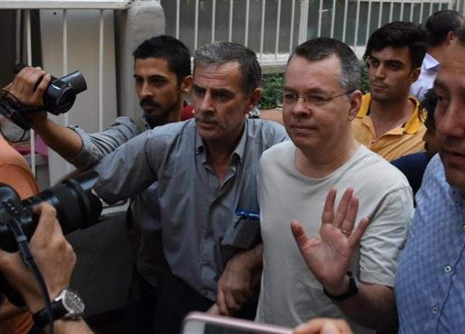 The file photo shows American pastor Andrew Brunson, in glasses, as he arrives at his home after being released from prison in Izmir, Turkey, on July 25, 2018. (Photo by Reuters)