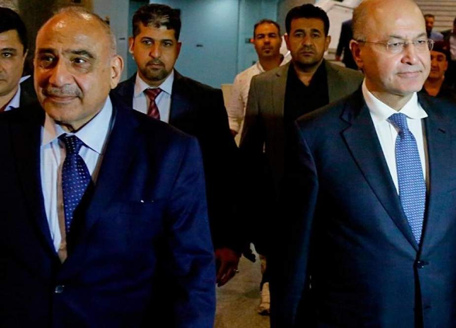 Iraq’s new president Barham Salih, right, with new prime minister Adel Abdul Mahdi, left, in the parliament building in Baghdad