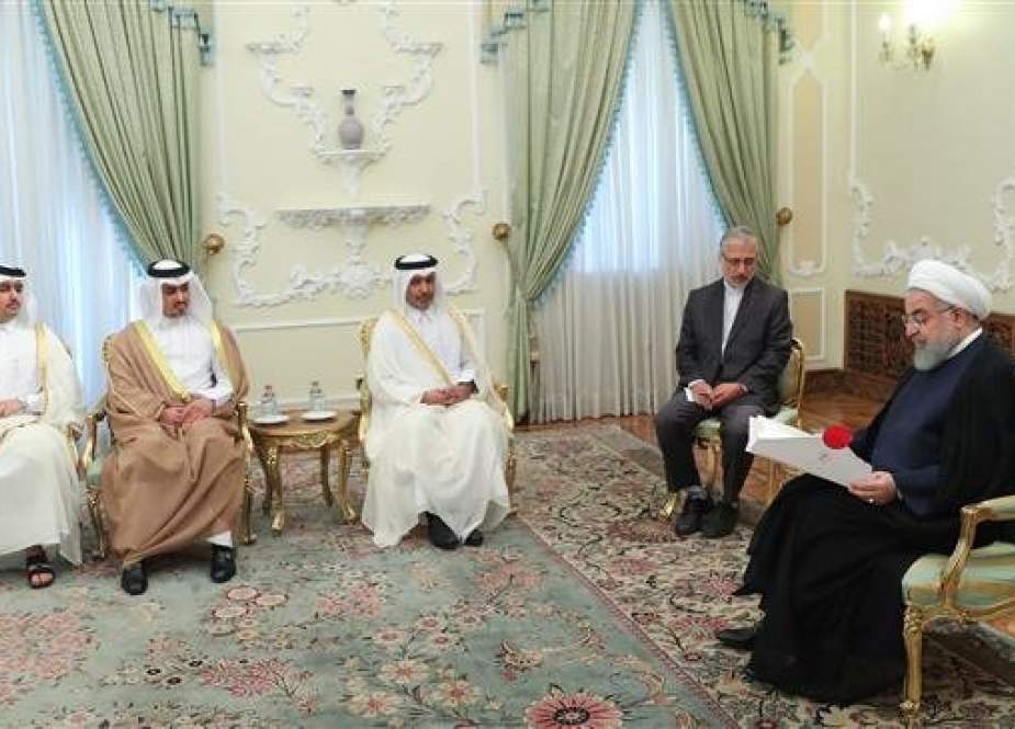 Iranian President Hassan Rouhani (R) receives the credentials of Qatar