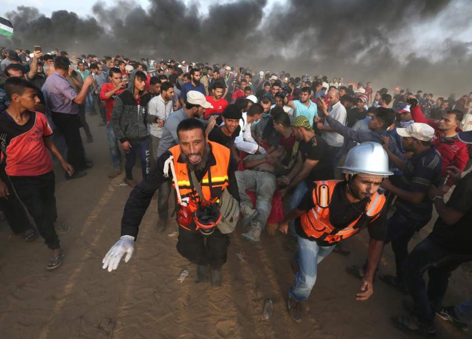 A wounded Palestinian is evacuated during a protest calling for lifting the Israeli blockade on Gaza and demanding the right to return to their homeland, at the Gaza border fence in the southern Gaza Strip October 19, 2018. (Photo by Reuters)