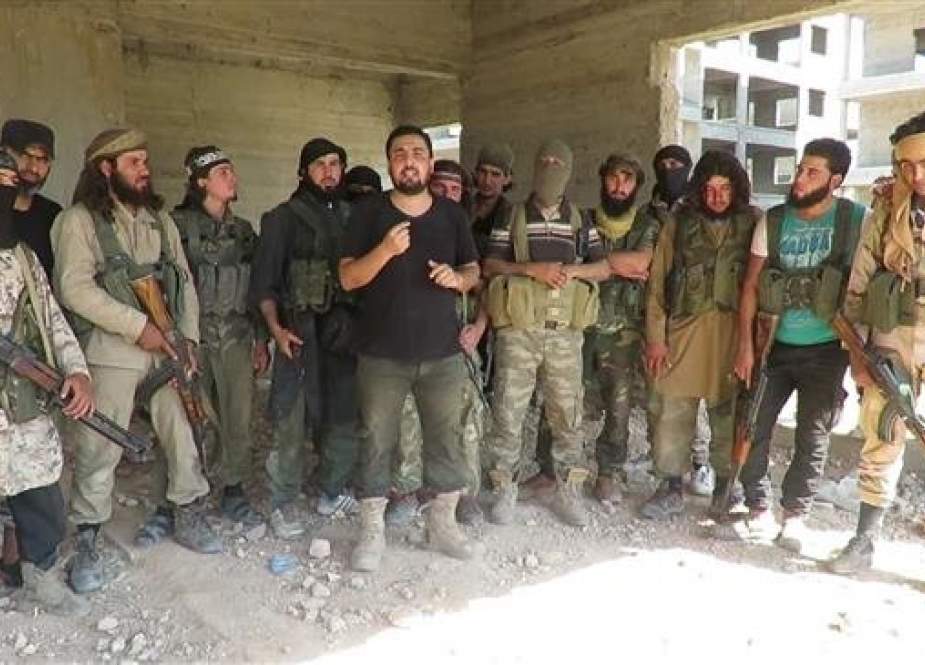 This file picture shows members of the Jabhat Fateh al-Sham, formerly known as al-Nusra Front, Takfiri terrorist group in an undisclosed location in Syria.
