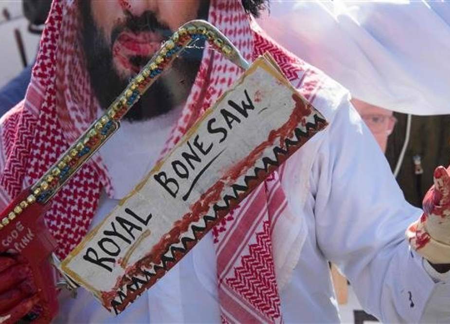 A demonstrator dressed as Saudi Arabian Crown Prince Mohammed bin Salman holds the royal bone saw outside the White House in Washington, DC, on October 19, 2018, as protesters demand justice for missing Saudi journalist Jamal Khashoggi. (Photo by AFP)