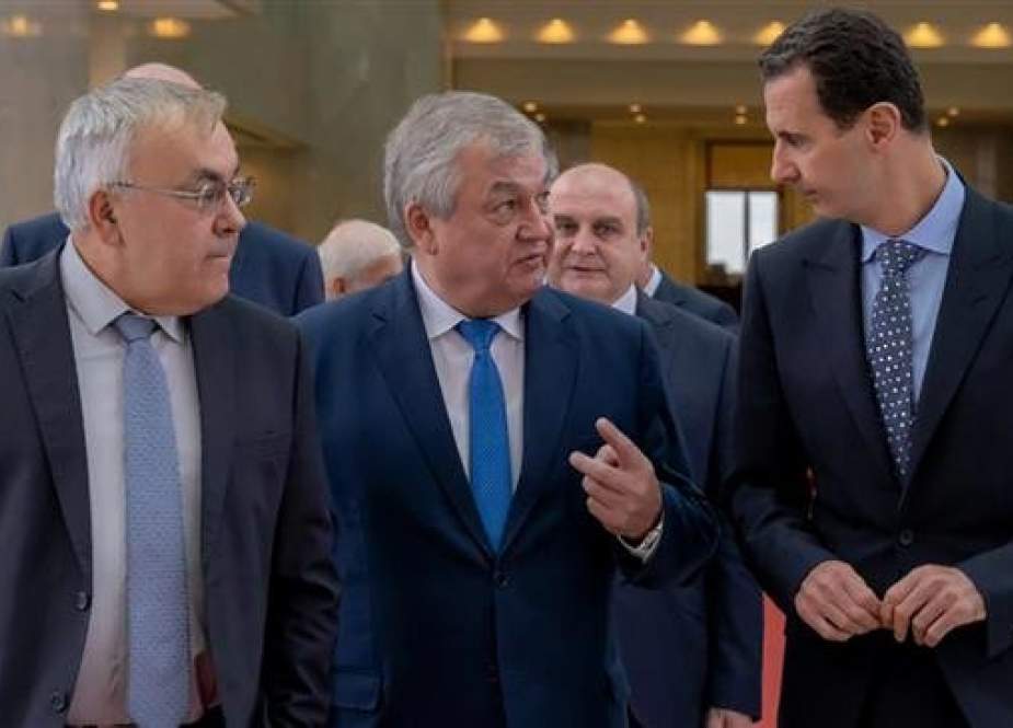 This handout picture made available by the Syrian Presidency office on November 4, 2018 shows Syrian President Bashar al-Assad, right, receiving Russian special envoy to Syria Alexander Lavrentiev, center, and Russian Deputy Foreign Minister Sergei Verchinen in the Syrian capital, Damascus. (Via AFP)