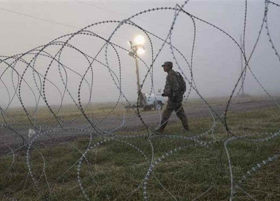A US Army soldier stands on guard duty near the US-Mexico border on November 5, 2018 in Donna, Texas. (Photo by AFP)