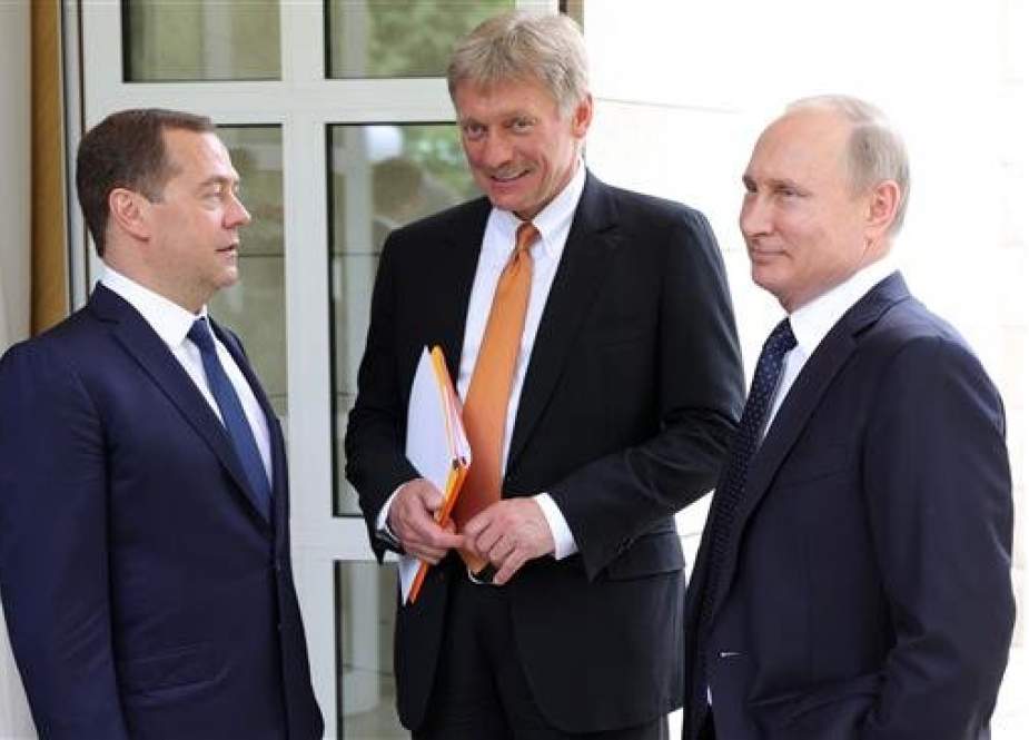 The file photo, taken on May 18, 2018, shows Russian President Vladimir Putin, right, the presidential spokesman Dmitry Peskov, center, and Prime Minister Dmitry Medvedev speaking in Sochi. (Photo by AFP)