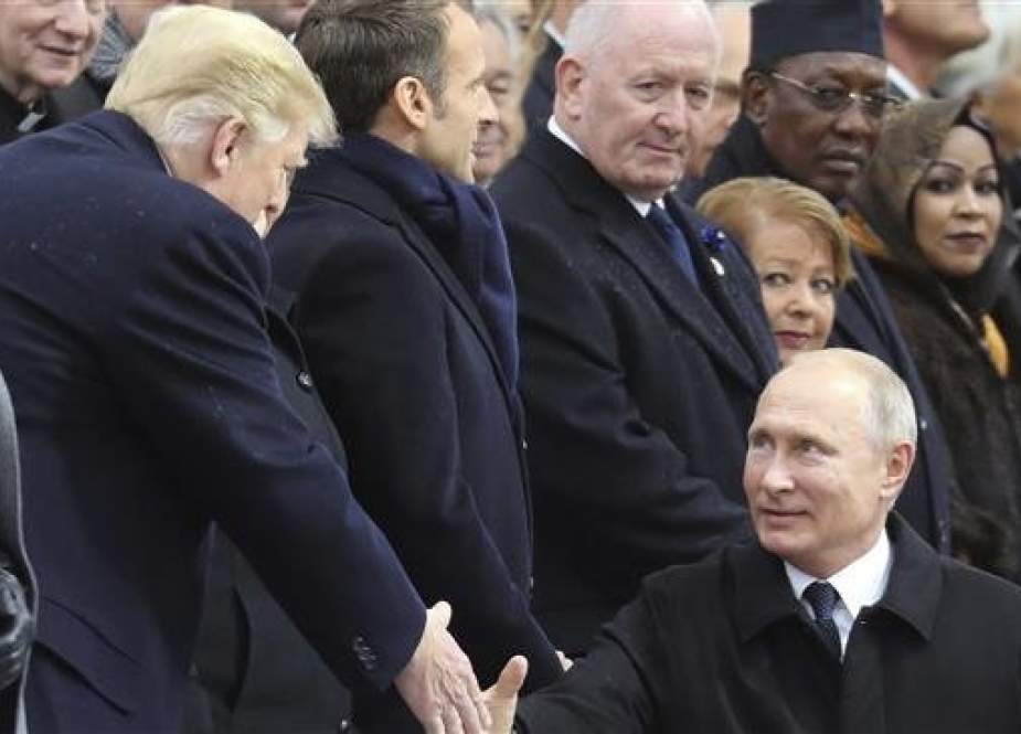 Russian President Vladimir Putin shakes hands with US President Donald Trump in Paris, November 11, 2018.(Photo by AP)