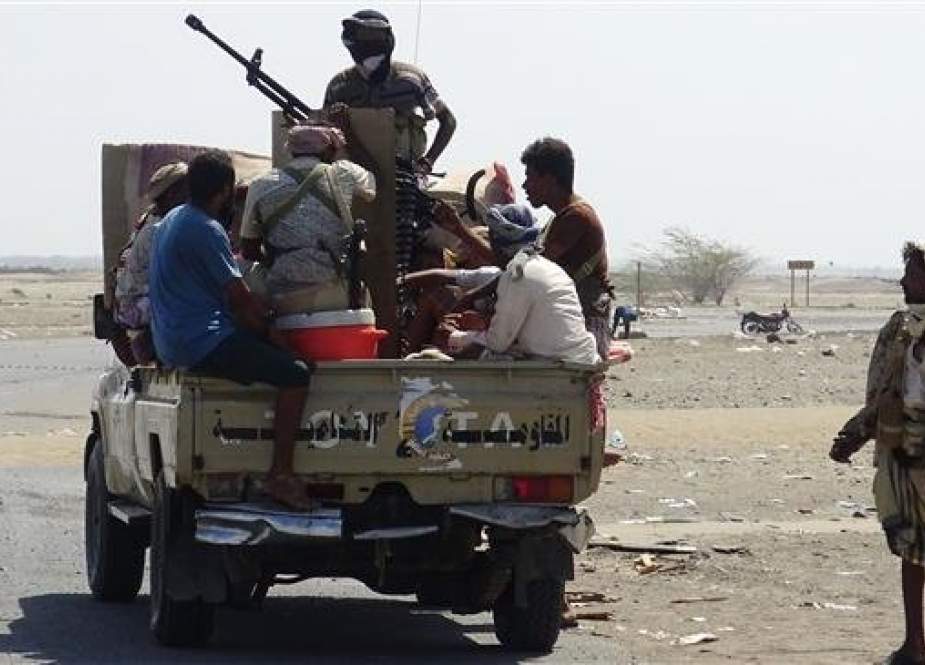 Saudi-backed militants gather in a street on the eastern outskirts of Hudaydah as they continue to battle for the control of the Yemeni city from Houthi Ansarullah fighters on November 13, 2018. (Photo by AFP)