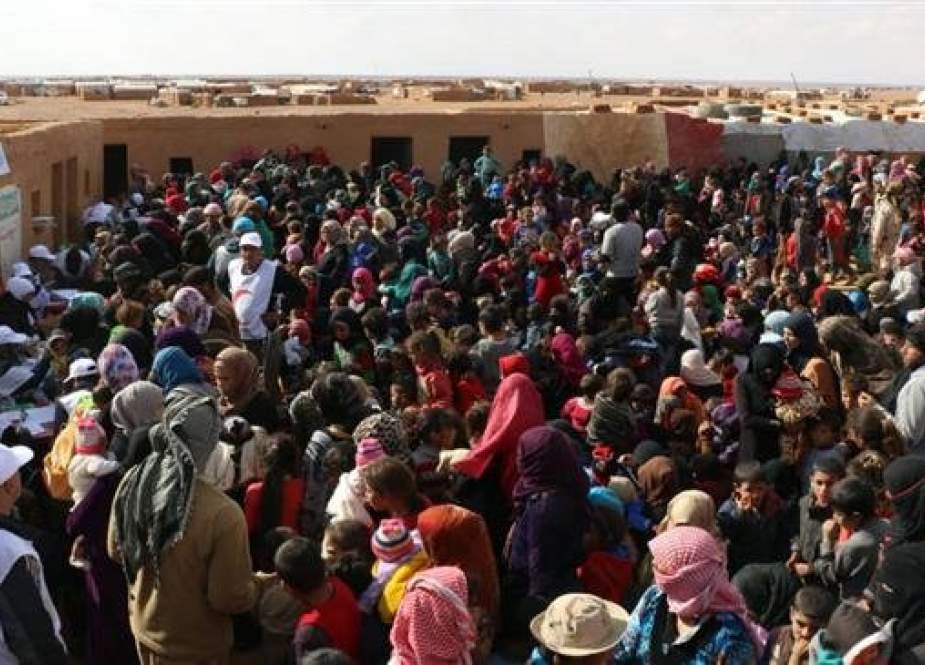 The handout photo released by the Syrian Arab Red Crescent on November 5, 2018, shows displaced Syrians receiving vaccinations at the Rukban camp on the Syrian-Jordanian border. (Via AFP)