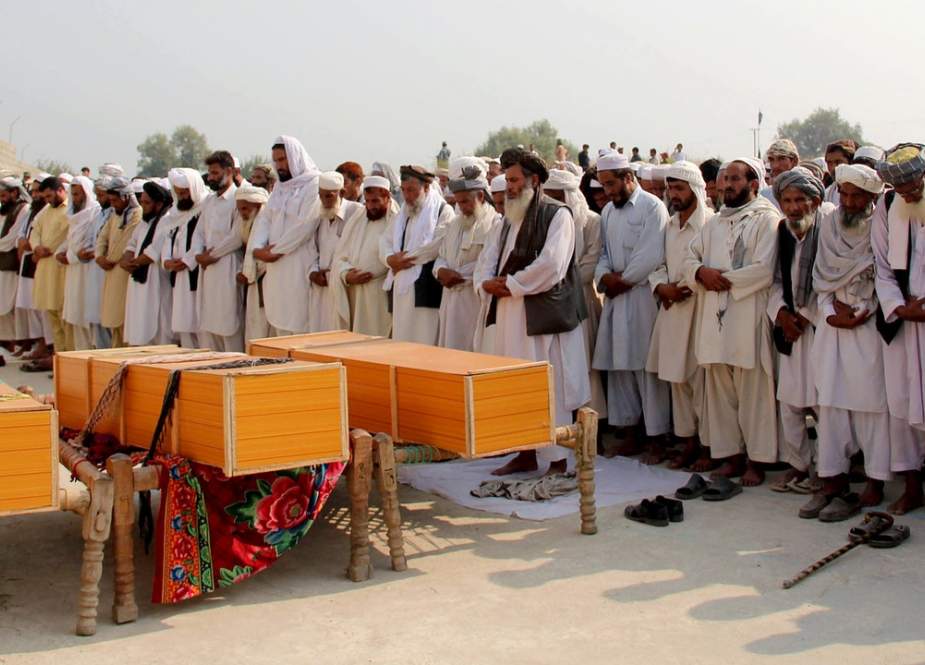 Afghan men offer funeral prayers for civilians killed in a NATO airstrike, on the outskirts of Jalalabad, Afghanistan,