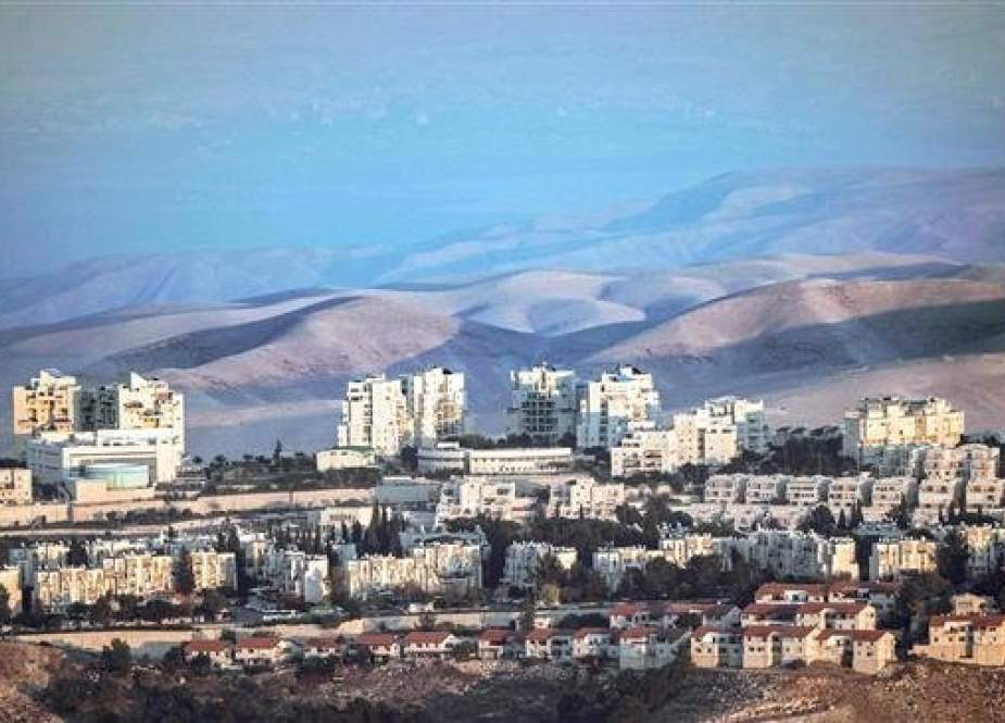 This picture, taken on November 17, 2018, from East Jerusalem al-Quds shows a view of the illegal Israeli settlement of Maale Adumim (C) with the Judaean desert seen in the background. (By AFP)