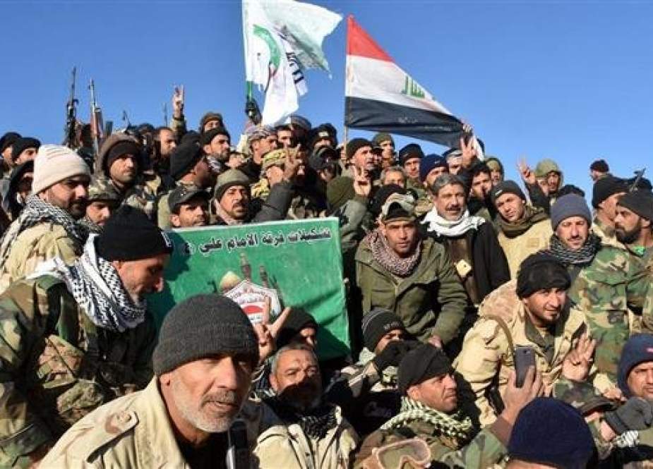 Hashd al-Sha’abi forces celebrate their victory over Daesh terrorists west of the Iraqi border town of al-Qa