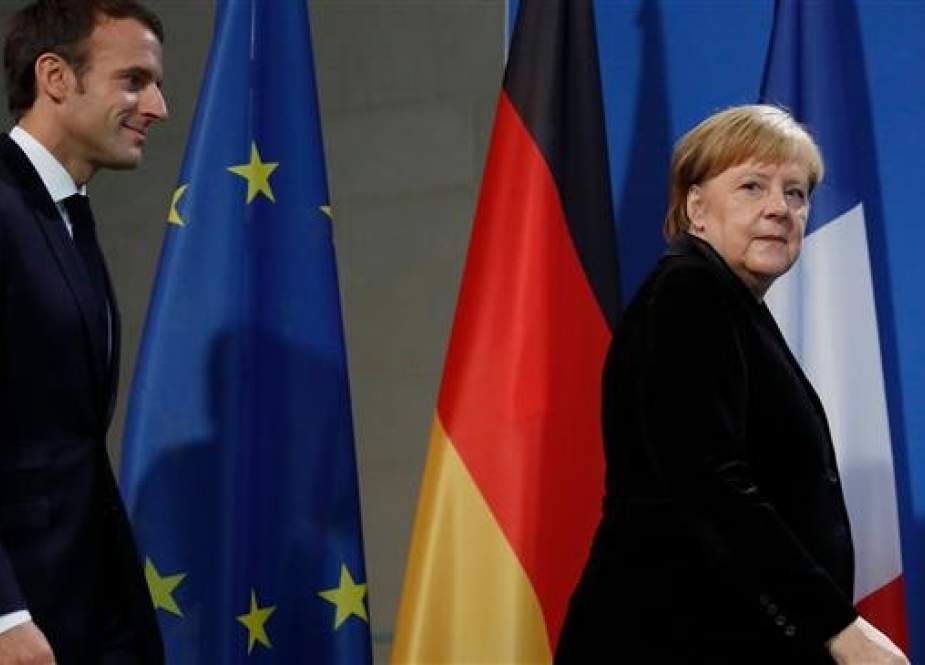 French President Emmanuel Macron (L) and German Chancellor Angela Merkel arrive for a press statement prior to talks on November 18, 2018 at the Chancellery in Berlin. (Photo by AFP)