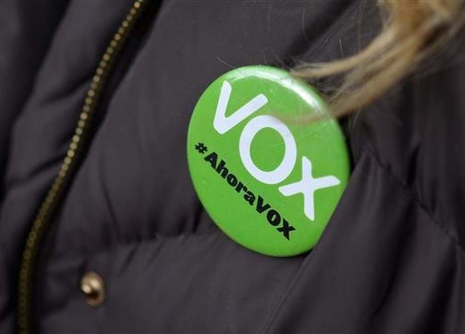 Picture taken on December 01, 2018 shows a woman wearing a pin that reads "Vox, now" during a demonstration called by the far-right VOX party. (Photo by AFP)