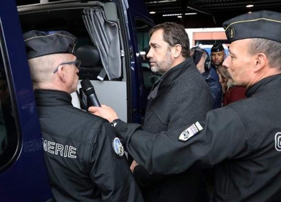 French Interior minister Christophe Castaner (C) is seen among security forces on December 7, 2018 in Versailles-Satory, west of Paris. (Photo by AFP)