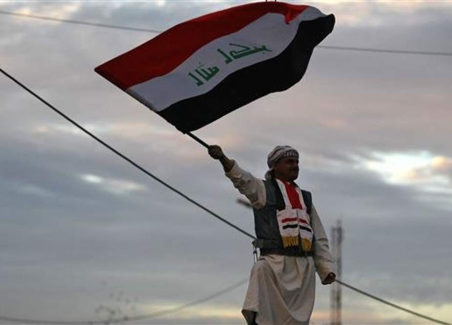 In this file photo, taken on December 10, 2017, an Iraqi man is seen waving a national flag in Baghdad