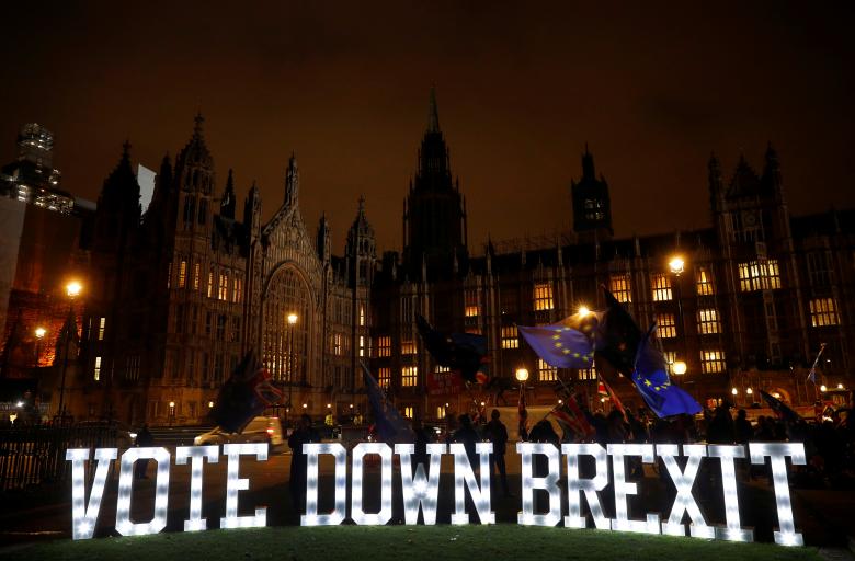 Anti-Brexit protesters are seen outside the Houses of Parliament in London, December 10, 2018.