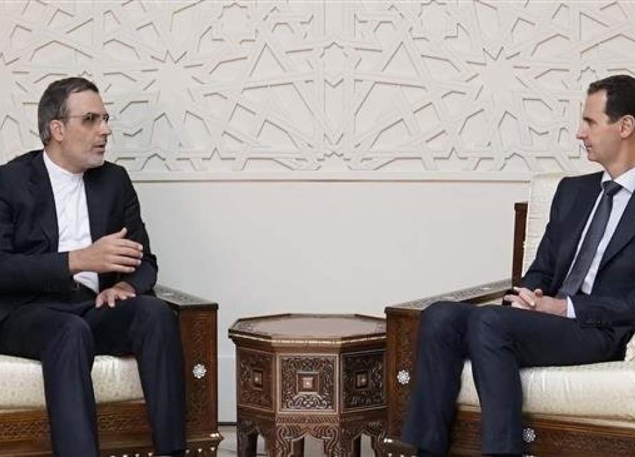 A handout picture released by the official Syrian Arab News Agency (SANA) on November 12, 2018 shows Syrian President Bashar al-Assad (R) meeting with assistant Iranian foreign minister, Hossein Jaberi Ansari, in Damascus.