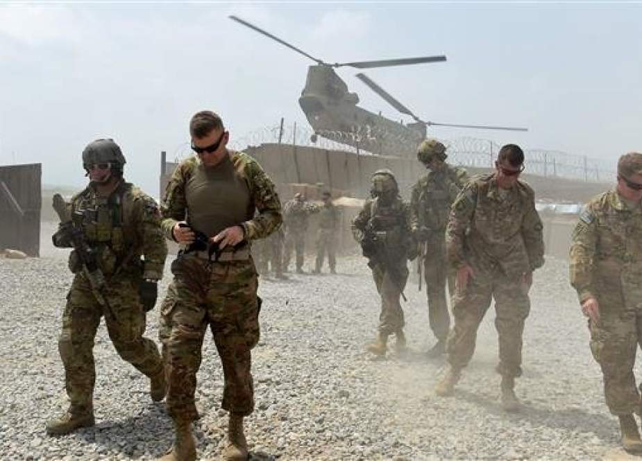 The undated photo shows US army soldiers walking at Forward Operating Base (FOB) Connelly in the Khogyani district in the eastern province of Nangarhar, Afghanistan, as a NATO helicopter flies overhead. (AFP)