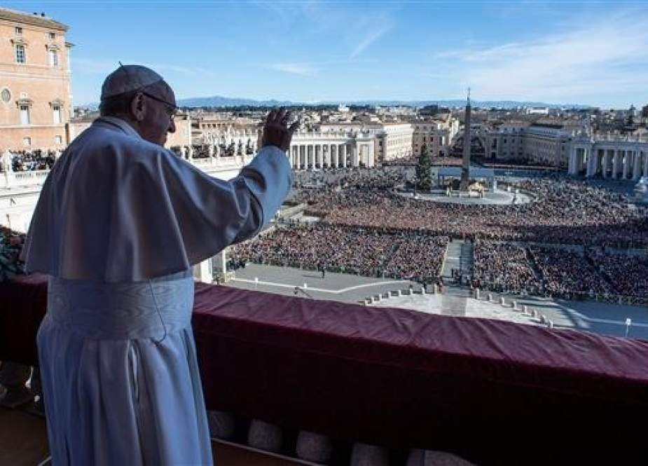 In this handout picture released by the Vatican press office on December 25, 2018, Pope Francis, the head of the Roman Catholic Church, waves as he arrives to deliver his annual Christmas message from a balcony above Saint Peter’s Square in Vatican City. (Via Reuters)