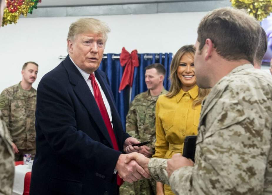 US President Donald Trump and First Lady Melania Trump arrive to speak to members of the US military during an unannounced trip to Al Asad Air Base in Iraq on December 26, 2018. (Photo by AFP)