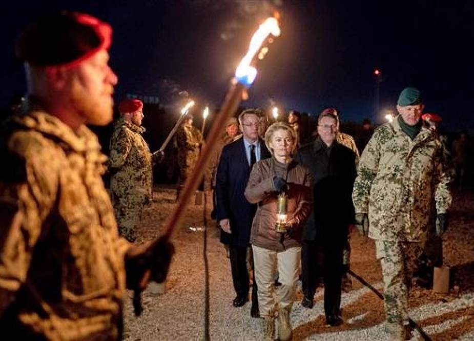 The file photo shows German Defense Minister Ursula von der Leyen, center, walking next to Brigadier General Gerhard Klaffus at Camp Marmal in Mazar-i-Sharif, northern Afghanistan, during a troop visit on December 17, 2018. (AFP)