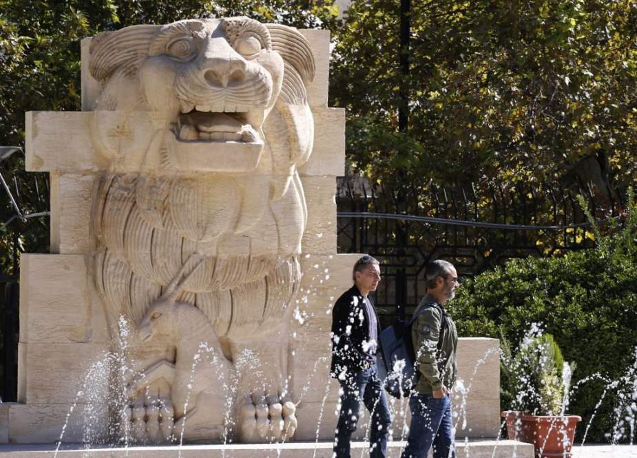 Visitors walk in front of the Lion of al-Lat, an ancient statue from the temple of the same name in Palmyra, during their visit to the national antiquities museum in the Syrian capital Damascus on October 28, 2018. (Photo by AFP)